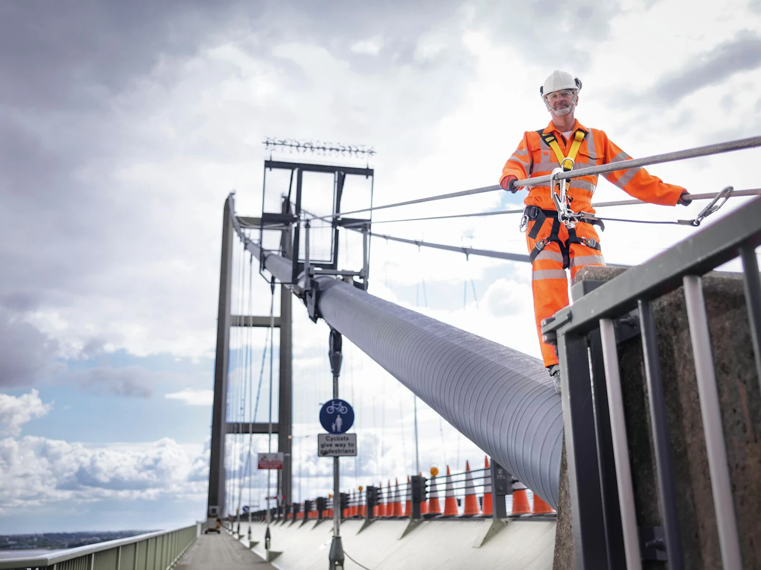 Worker on Suspension Bridge