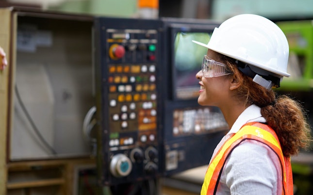 Factory Engineer Examining Production Line Machinery