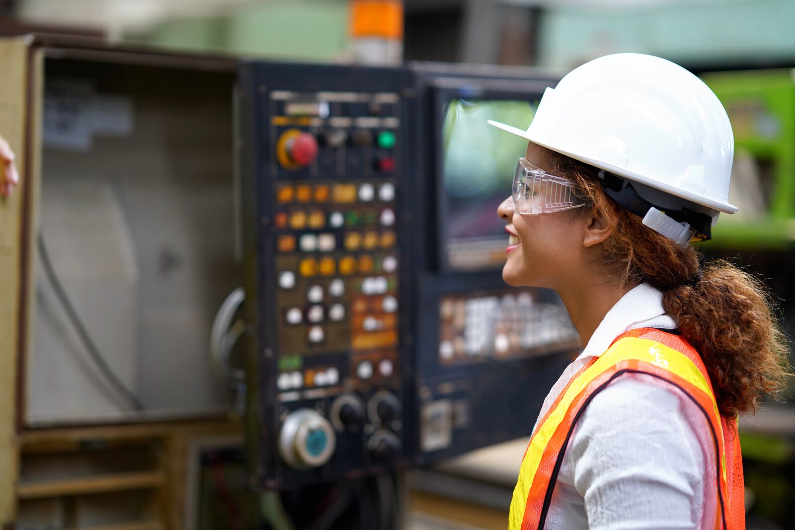 Factory Engineer Examining Production Line Machinery