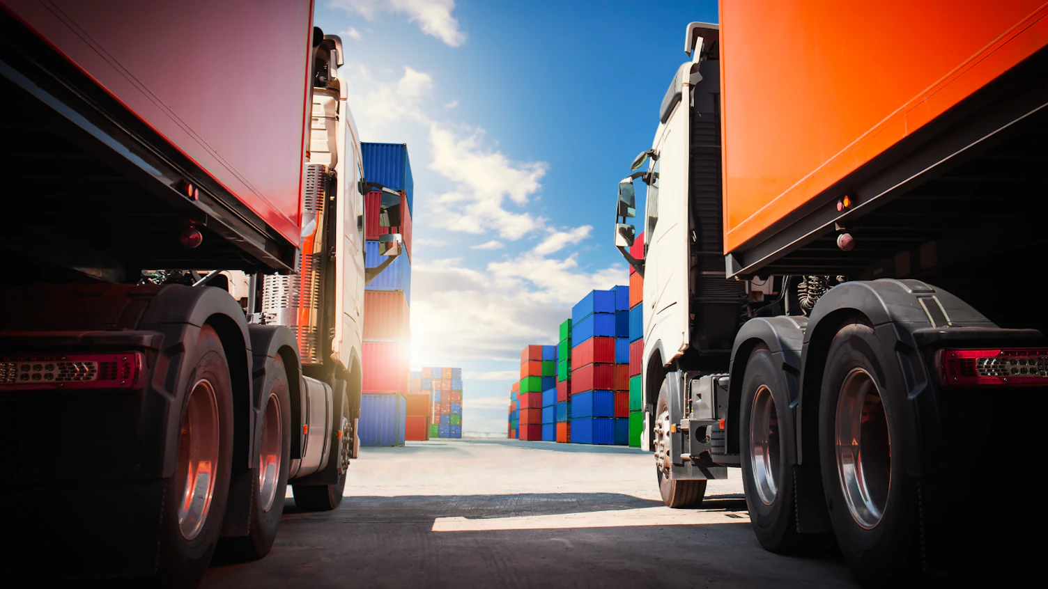 Semi trailer Trucks on The Parking Lot with Stacked Containers