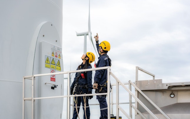 Engineers Inspecting a Wind Turbine Farm