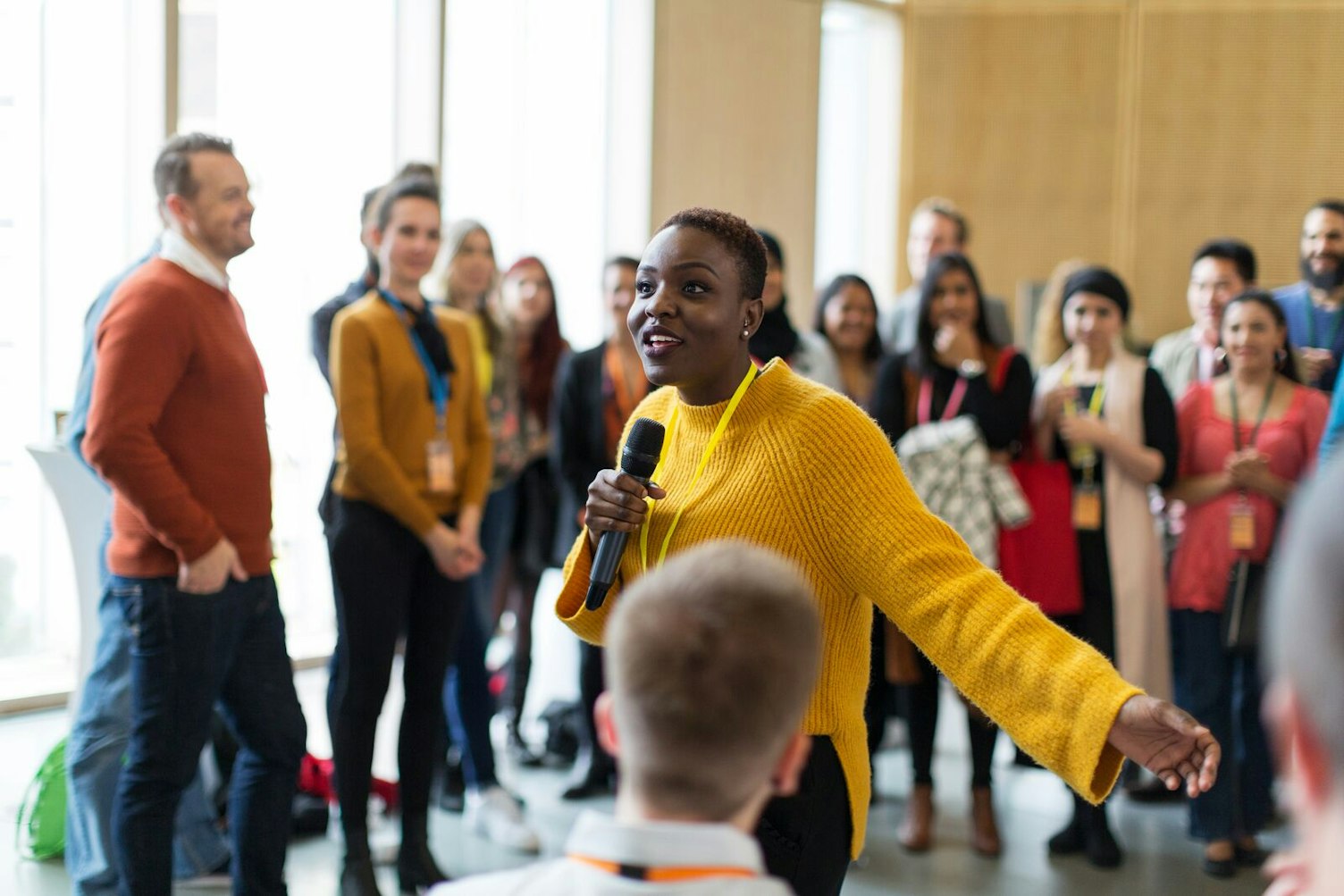 Audience Listening to Speaker Using a Microphone