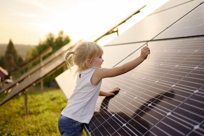 Little Girl Next to Solar Panels
