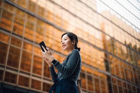 Businesswoman Using her Smartphone in the Street