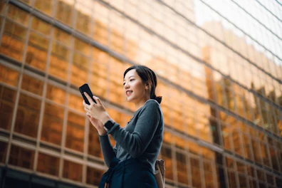 Businesswoman Using her Smartphone in the Street