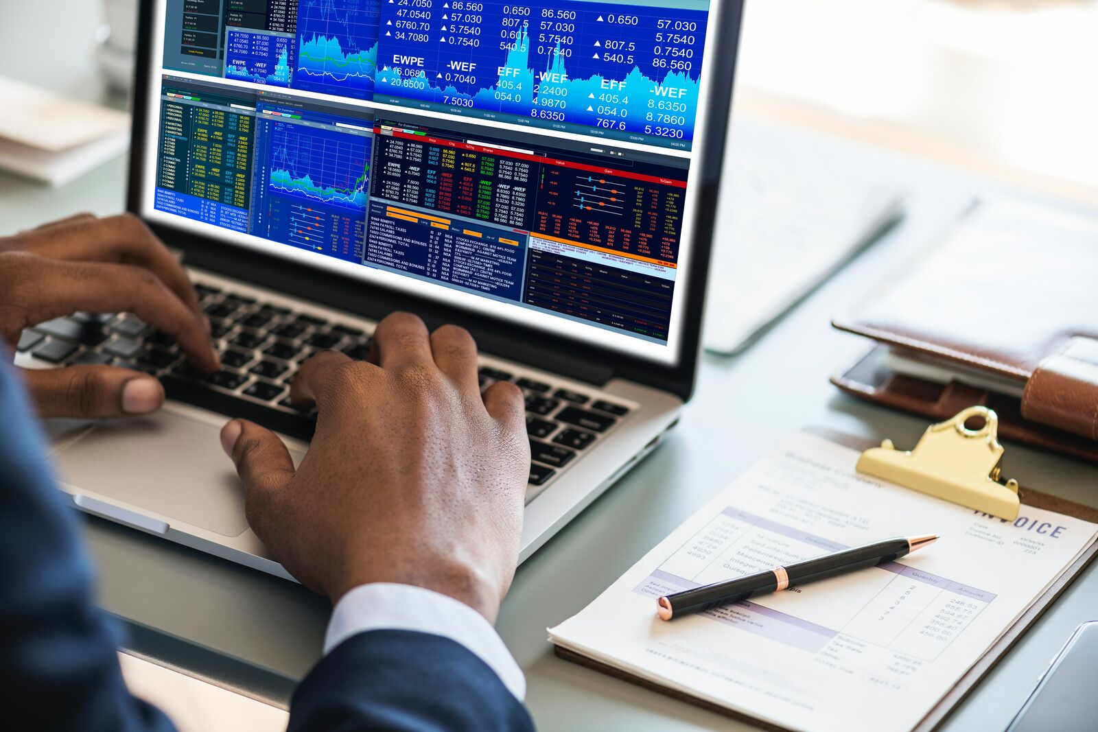Man Working on a Computer Looking at Data and Graphs
