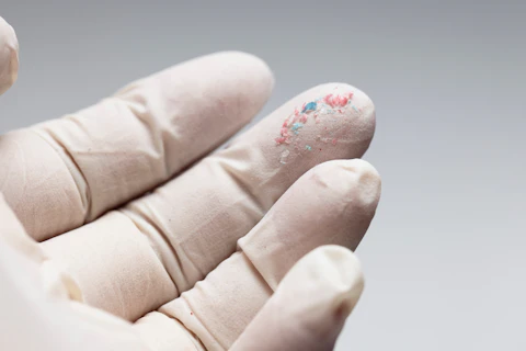 Close up View of Fingertips with Micro Plastic