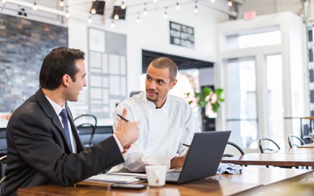 Auditor Meeting with Chef in a Restaurant