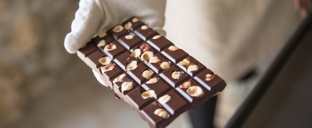 Chocolate Bar with Nuts Held by a Chef