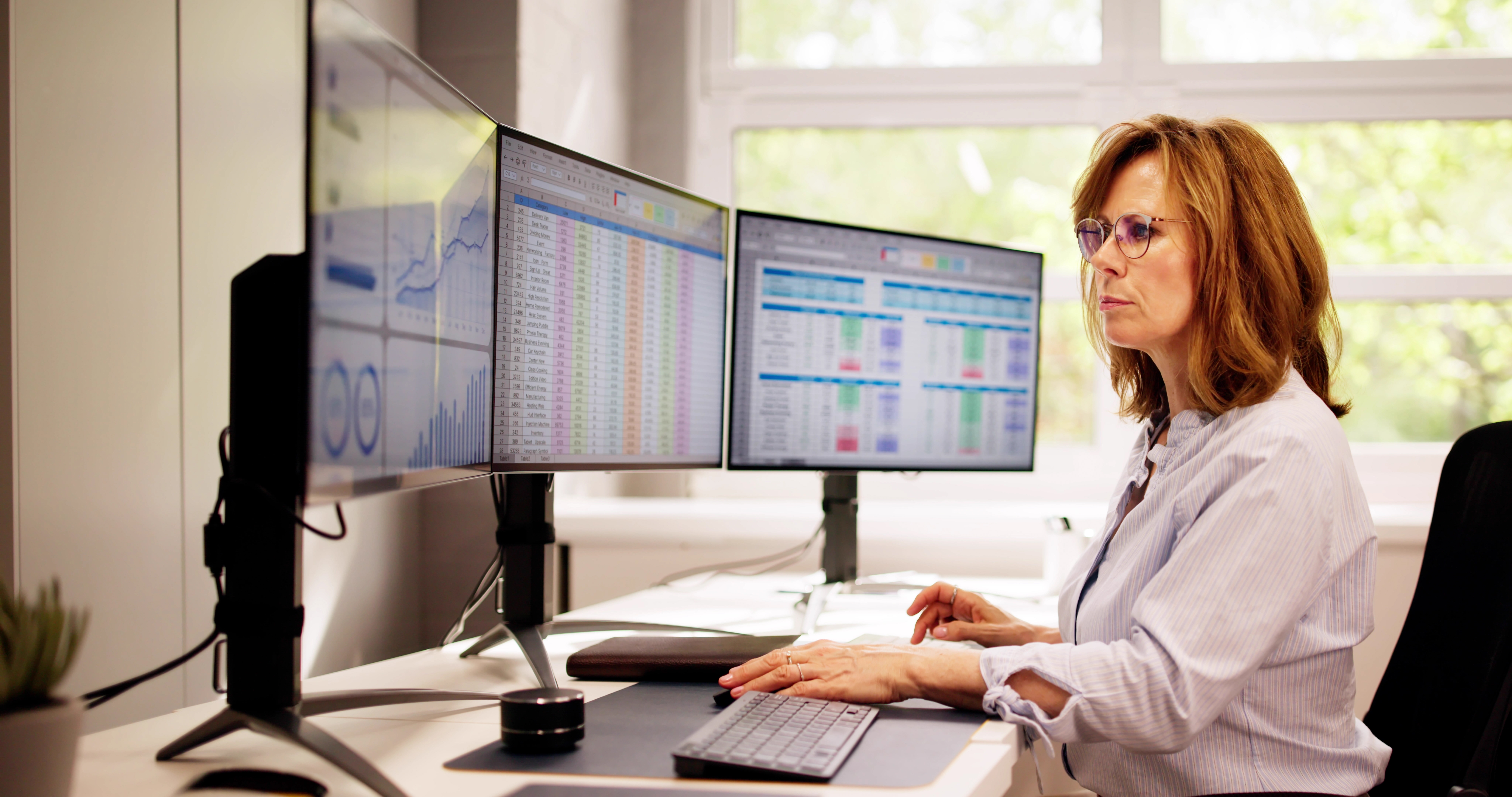 Computer Spreadsheet Data Analyst Woman Using Multiple Screens