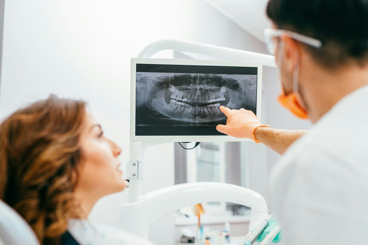 Dentist and Patient Looking at Digital X-Ray