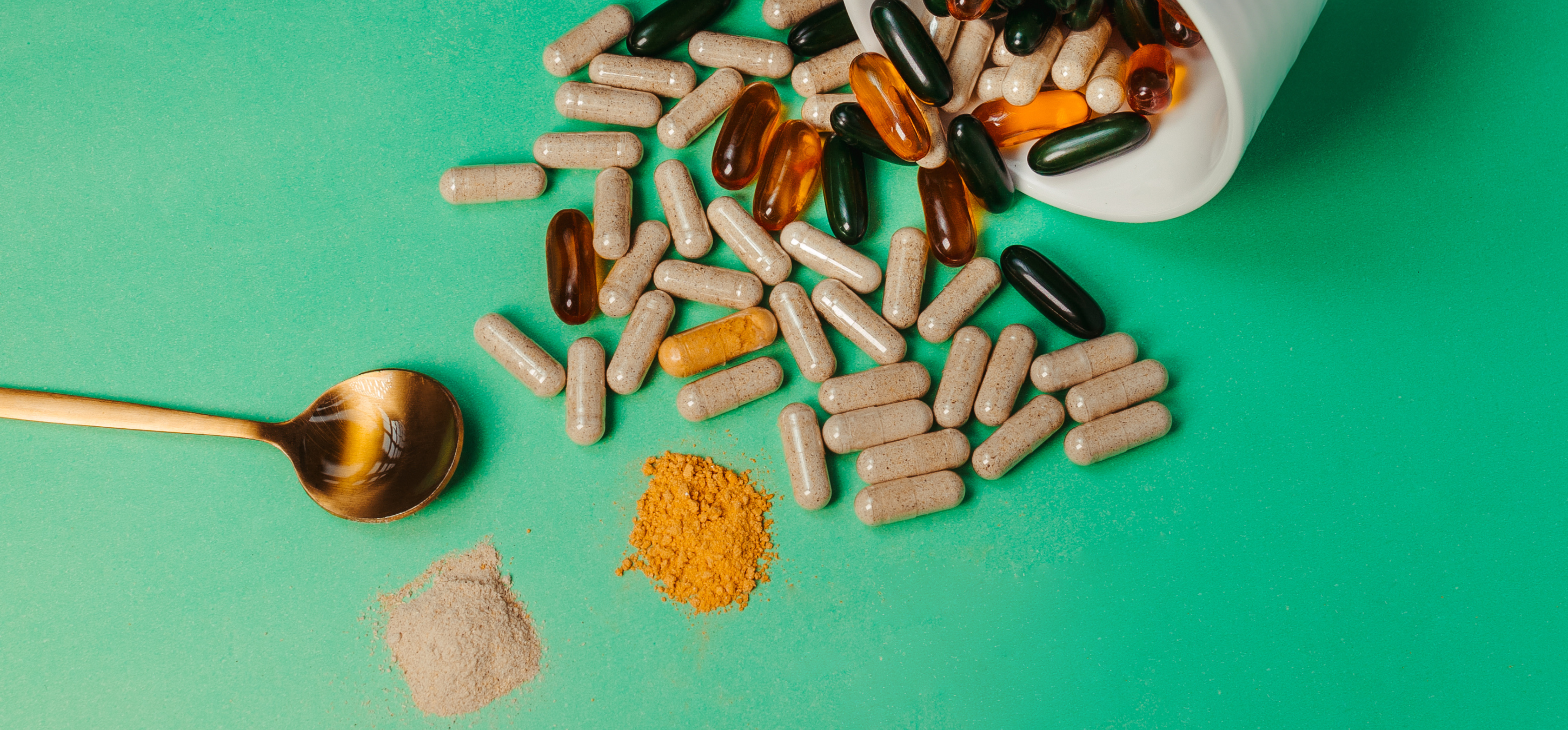 Dietary supplements pills and tablets with a spoon and powder