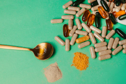 Dietary supplements pills and tablets with a spoon and powder