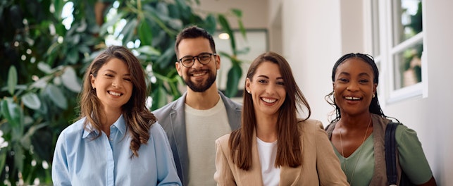 Happy multiracial group of creative business people in the office looking at camera.