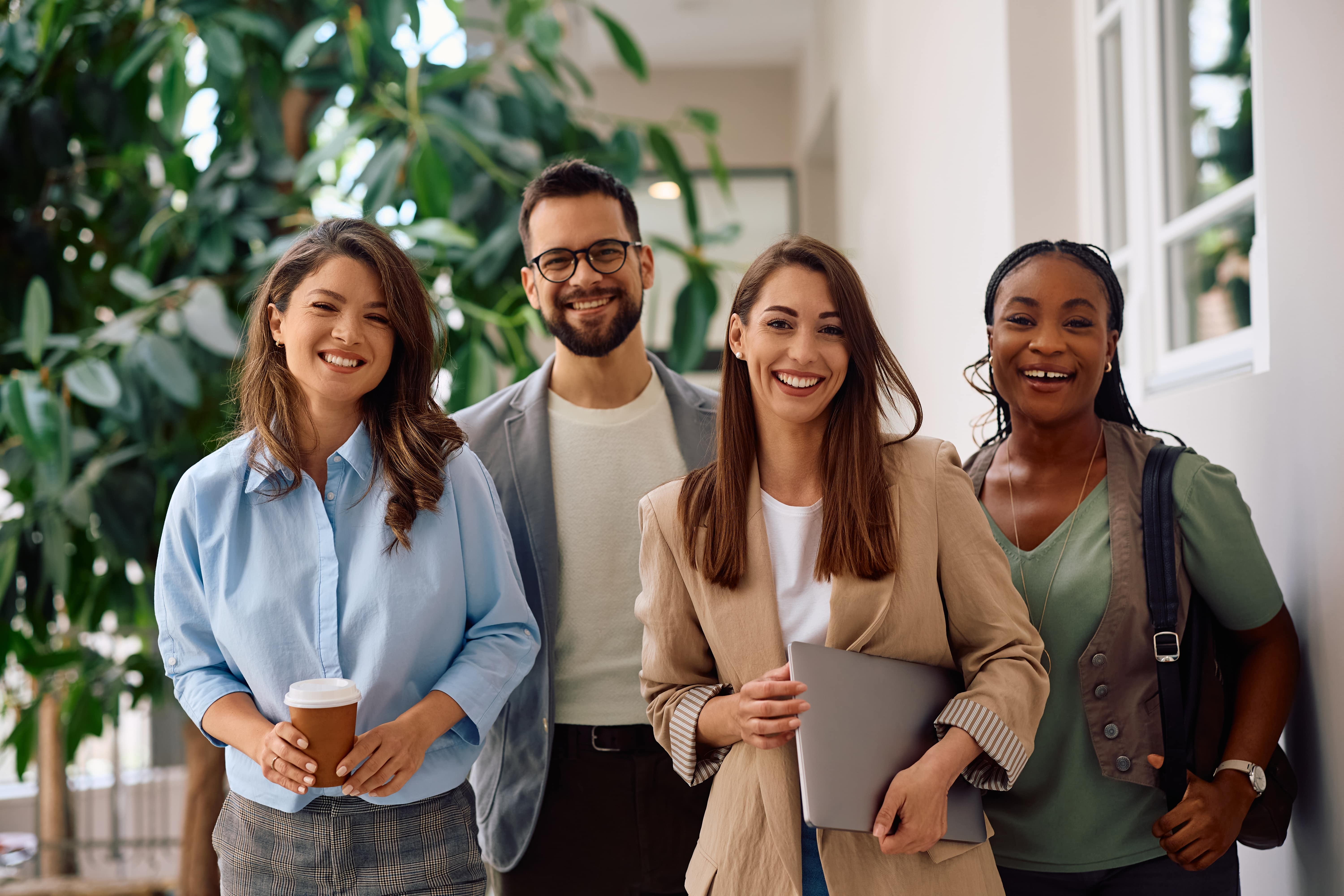 Happy multiracial group of creative business people in the office looking at camera.