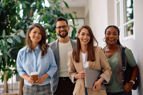 Happy multiracial group of creative business people in the office looking at camera.