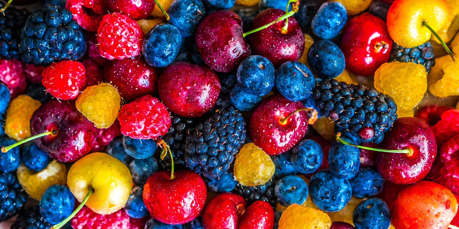 Mix of berries on wooden background