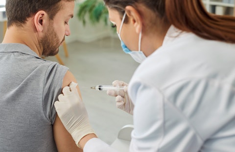 Nurse or Doctor Giving Injection in the Shoulder to Male Patient