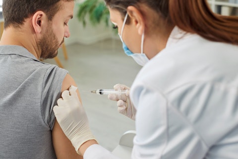 Nurse or Doctor Giving Injection in the Shoulder to Male Patient