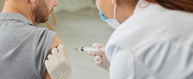 Nurse or Doctor Giving Injection in the Shoulder to Male Patient