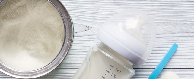 Preparation of mixture baby feeding on wooden background top view