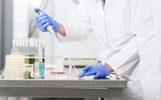 Research operator preparing samples in petri dishes