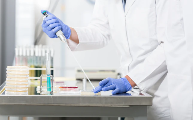 Research operator preparing samples in petri dishes
