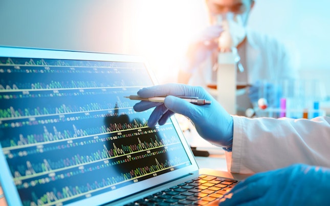 Scientist Looking at DNA Sequence on a Computer