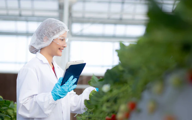 Scientist Working in Greenhouse Laboratory