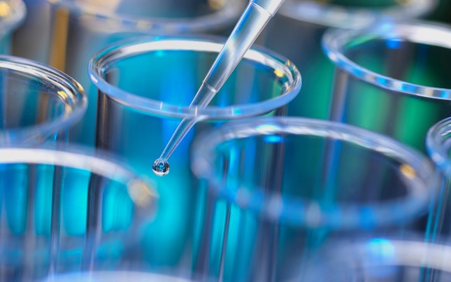 Solution Being Pipetted into Test Tubes for Analysis in Laboratory