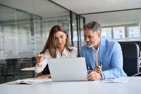 Two busy happy middle aged professional business man and woman executive leaders