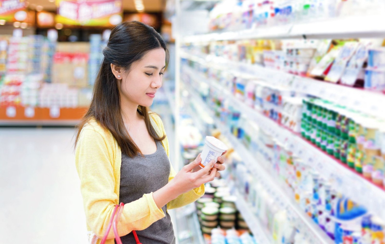 Woman Buying Dairy Product in a Supermarket