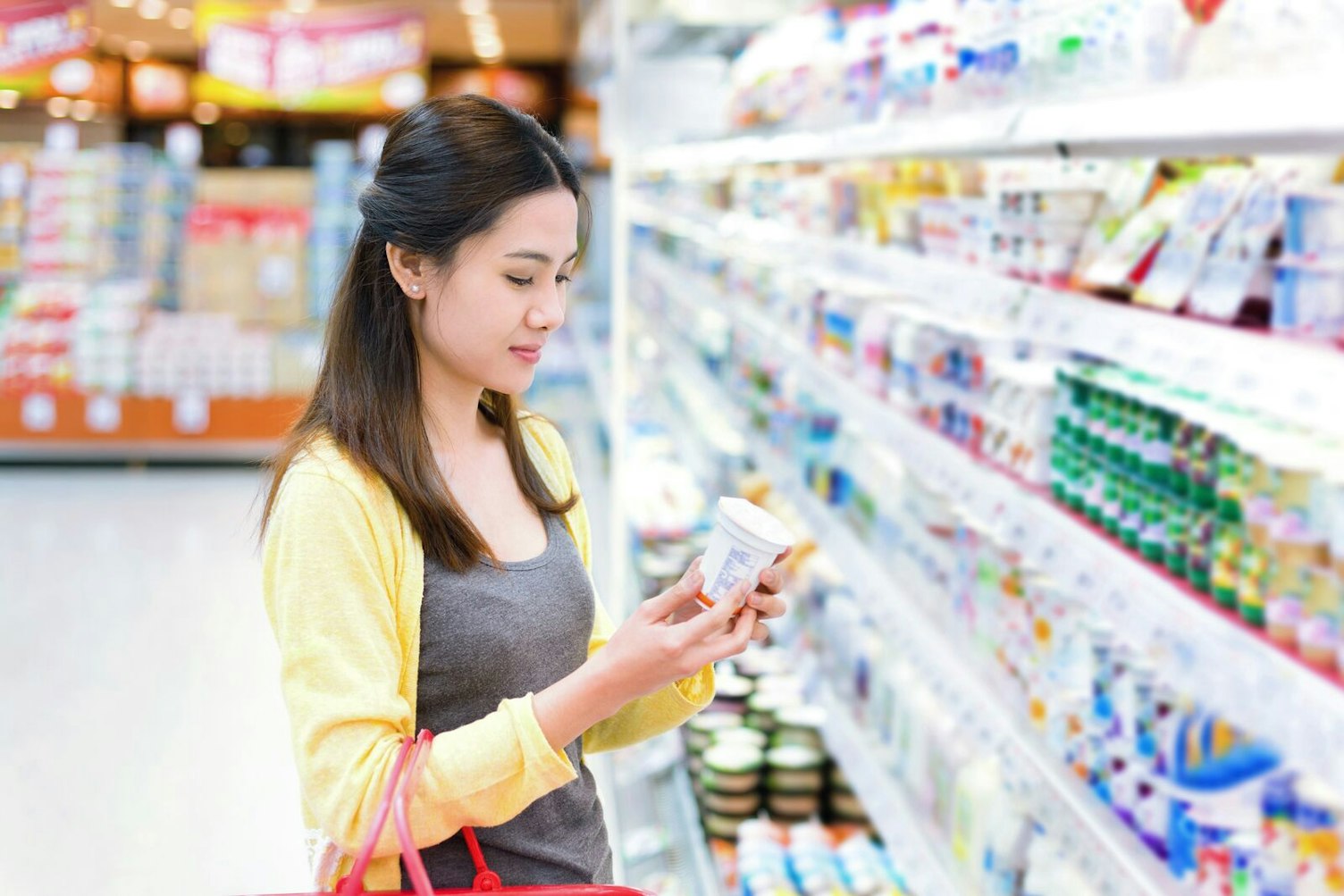 Woman Buying Dairy Product in a Supermarket