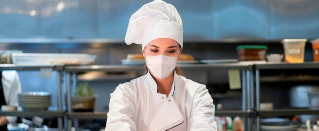 Woman Chef Working at a Restaurant Wearing Face Mask