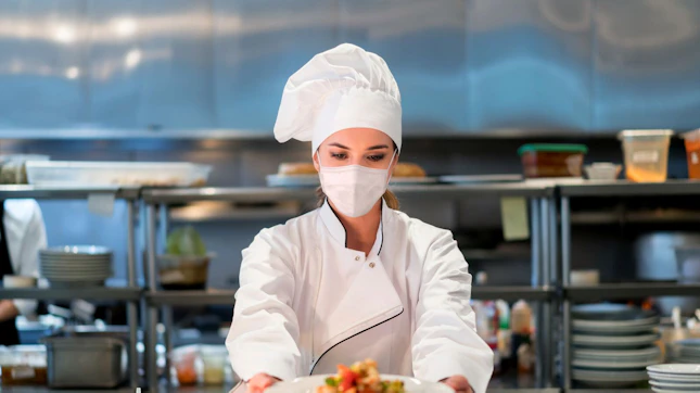 Woman Chef Working at a Restaurant Wearing Face Mask