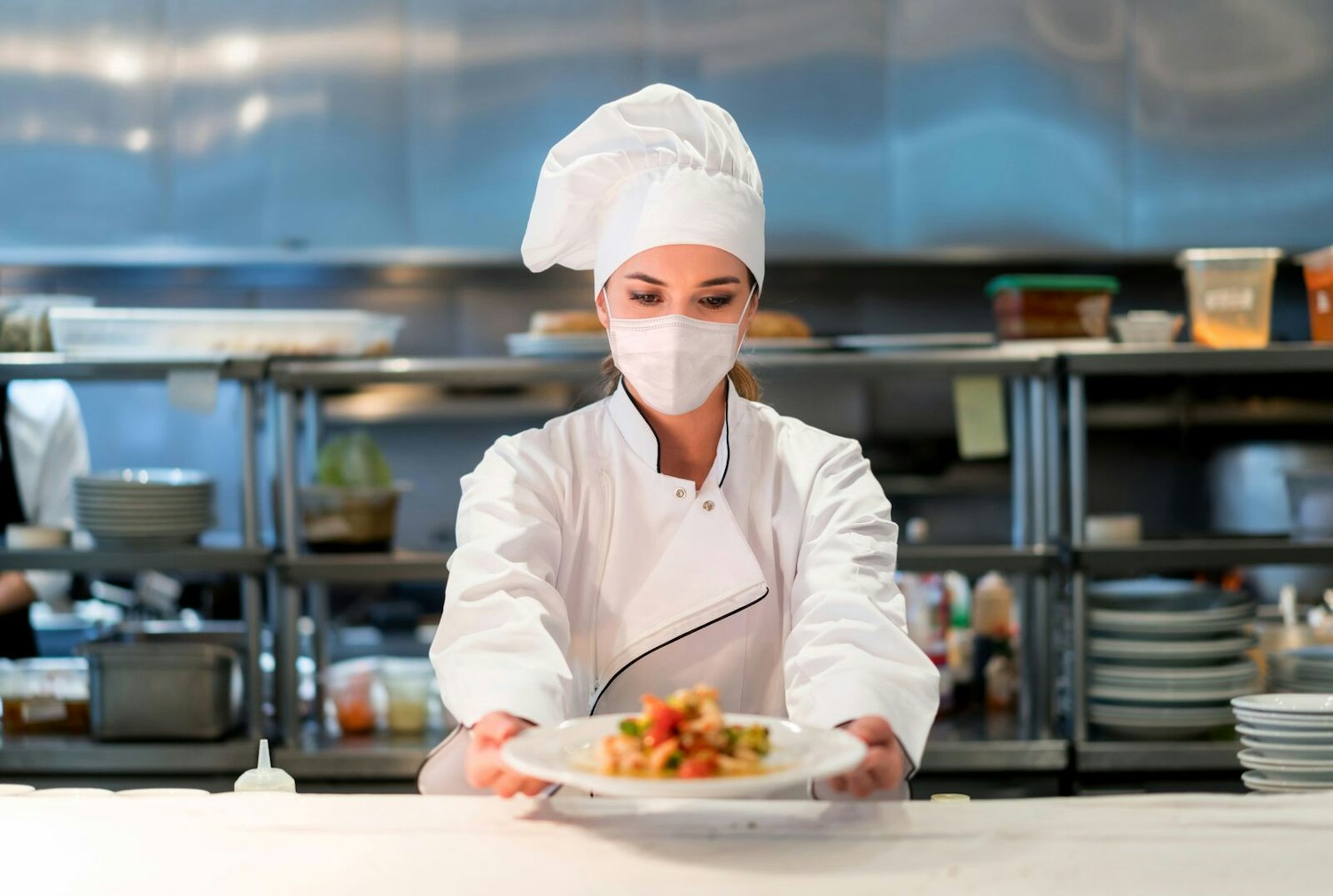 Woman Chef Working at a Restaurant Wearing Face Mask
