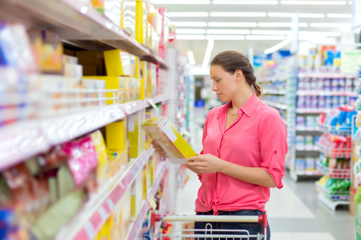 Woman Reading Food Facts in a Supermarket