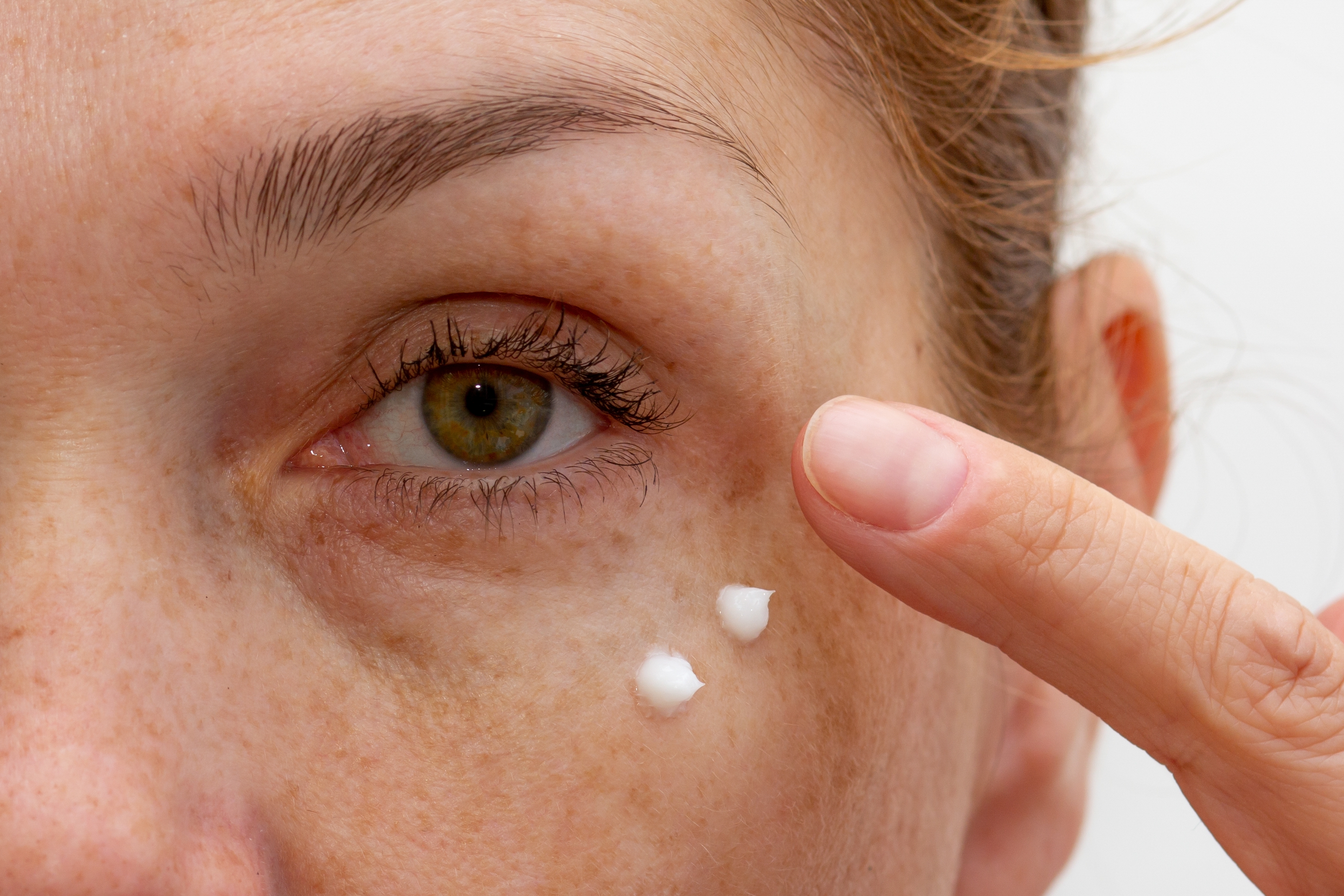 Women Applying Cream on her Face
