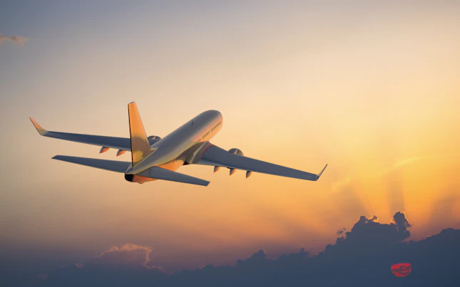 Aircraft Flying Above Clouds at Sunset