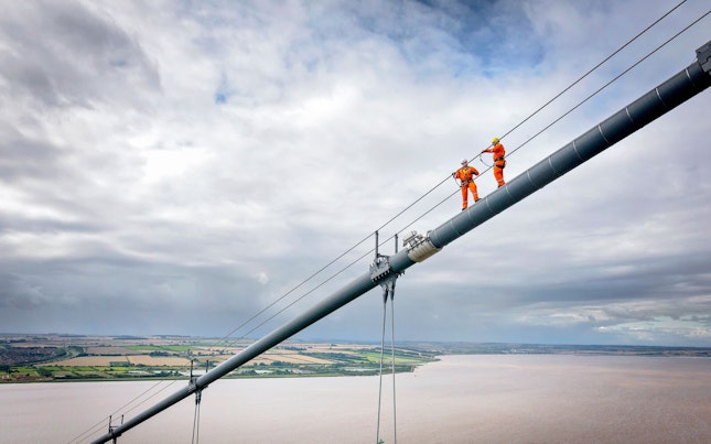 Bridge Workers Working on Cable of a Suspension Bridge