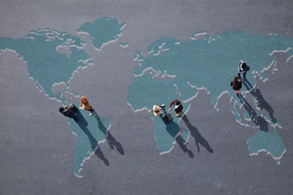 Businesspeople Standing on Painted World Map