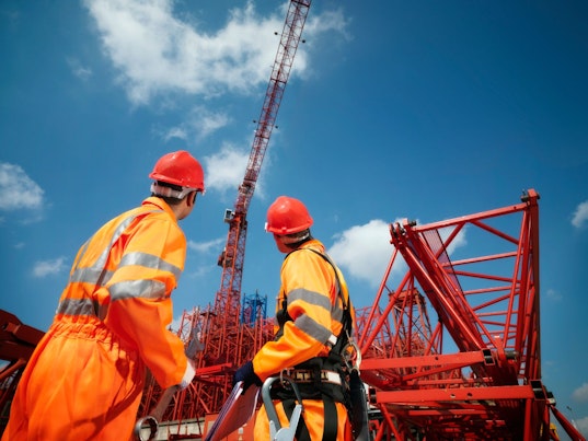Crane Workers Looking at Cranes