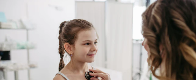 Doctor examining young girl