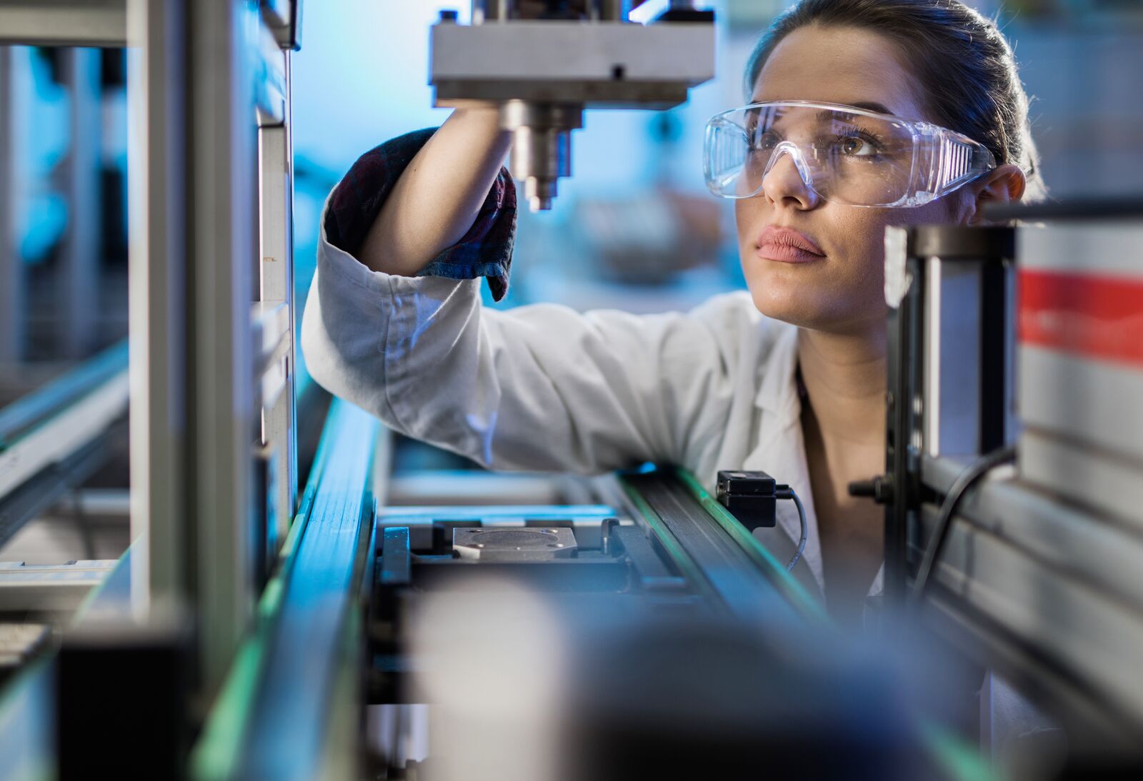 Engineer Examining Machine Part on a Production Line