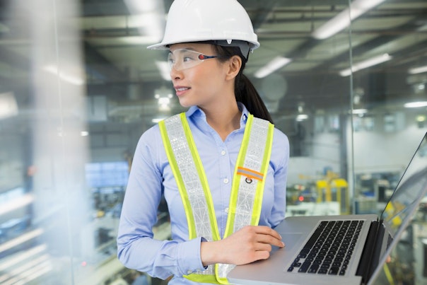 Engineer Working on Laptop in a Factory