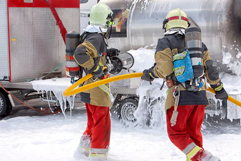Firemen Extinguishing a Fire with Foam