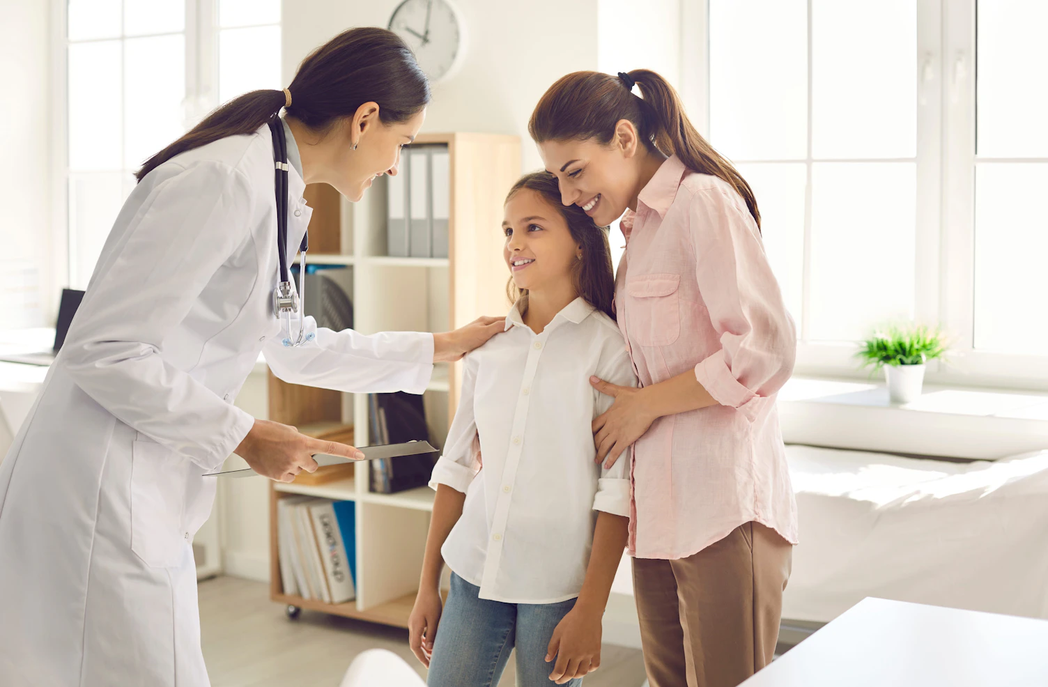 Mother and child seeing doctor together