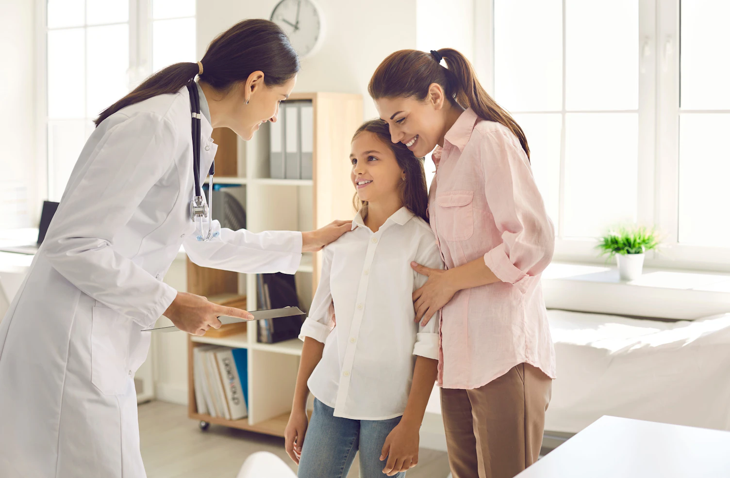 Mother and child seeing doctor together