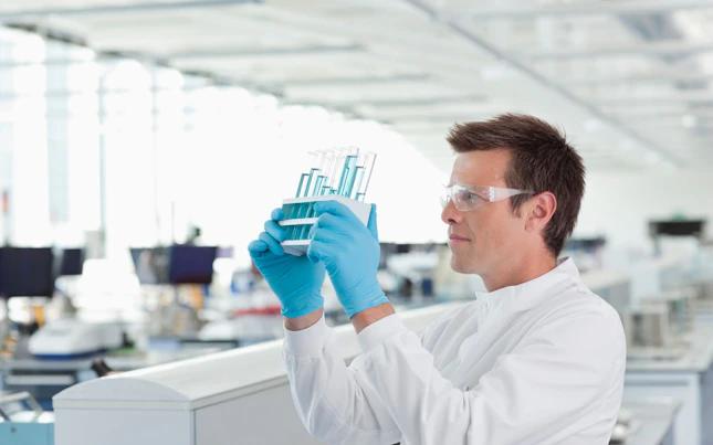 Scientist Examining Test Tubes in Laboratory