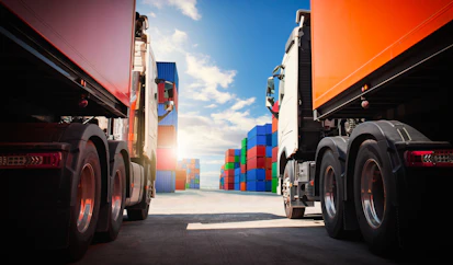 Semi trailer Trucks on The Parking Lot with Stacked Containers